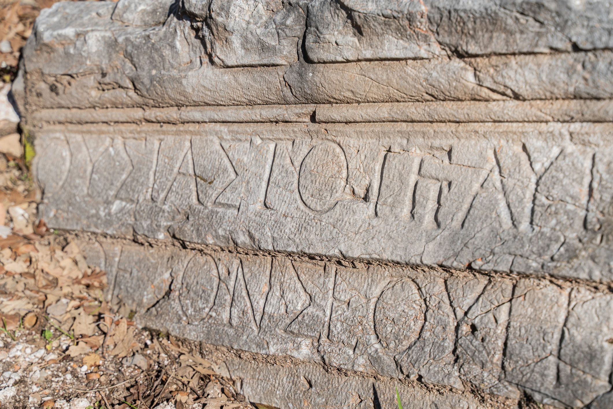 Close-up of an ancient stone inscription with carved letters